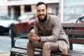 Happy young man with a beard holding a miniature house in his hands. Rental housing, inherited home Royalty Free Stock Photo