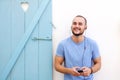 Happy young man with beard listening to music on mobile phone Royalty Free Stock Photo