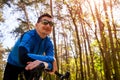 Happy young man bicyclist riding a road bike in spring forest. Man having rest Royalty Free Stock Photo