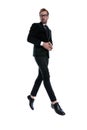 Happy young man in black suit joining hands and smiling Royalty Free Stock Photo