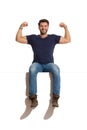 Happy Handsome Man Is Sitting On A Top And Flexing Muscles Royalty Free Stock Photo