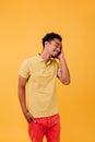 Happy young man in bright clothes enjoying photoshoot. Blithesome male model with short black hair