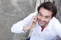 Happy young man calling by cell phone outdoors Royalty Free Stock Photo