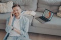 Happy young man calling family to inform about receiving promotion