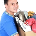 Happy young man carrying box full of stuff Royalty Free Stock Photo