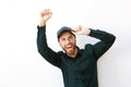 Happy young man cheering with arm raised abasing isolated white background