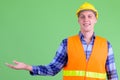 Happy young man construction worker showing something Royalty Free Stock Photo