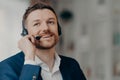 Happy young man consulting client by call Royalty Free Stock Photo