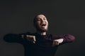 Happy young man dancing on a gray background. bald with a beard Royalty Free Stock Photo