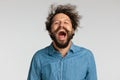 Happy young man in denim shirt with long beard having fun and laughing Royalty Free Stock Photo
