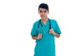 Happy young man doctor in blue uniform with stethoscop on his neck posing and looking at the camera and smiling isolated Royalty Free Stock Photo