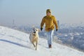 Happy young man with dog in winter Royalty Free Stock Photo