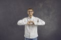 Happy young man doing a heart sign to show love and support and to say thank you Royalty Free Stock Photo