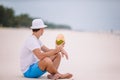 Young woman drinking coconut milk during tropical vacation Royalty Free Stock Photo