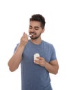 Happy young man eating tasty yogurt on background