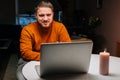 Happy young man enjoying distant dating using laptop computer, holding glass with wine, talking celebration toasting via Royalty Free Stock Photo