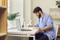 Happy young man enjoying fresh healthy takeaway meal during lunch break at work Royalty Free Stock Photo