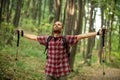 Happy young man enjoying a perfect peaceful moment during hike through forest. Arms outstretched