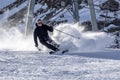 Happy young man enjoying winter vacations in mountains, Val Thorens, 3 Valleys, France. Playing with snow and sun in high mountain