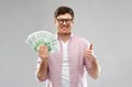 Happy young man with euro money showing thumbs up Royalty Free Stock Photo