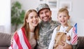Happy young man father in military uniform reunited with his beautiful american family Royalty Free Stock Photo