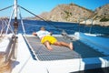 Happy young man feels happy on the luxury sail boat yacht catamaran in turquoise sea in summer holidays on island. Royalty Free Stock Photo