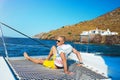 Happy young man feels happy on the luxury sail boat yacht catamaran in turquoise sea in summer holidays on island. Royalty Free Stock Photo