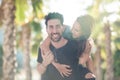 Happy young man giving his girlfriend a piggy back ride Royalty Free Stock Photo