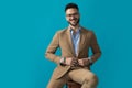 Happy young man with glasses smiling and adjusting suit Royalty Free Stock Photo