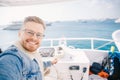 Happy young man goes on trip on white yacht sea, concept of travel and success search for yourself Royalty Free Stock Photo