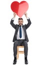 Happy young man holding big red heart above head Royalty Free Stock Photo