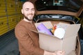 Happy young man holding a box with merchandise Royalty Free Stock Photo