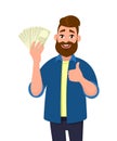 Happy young man holding cash/money/banknotes and showing thumbs up or like sign. Financial money concept. Human emotion concept.