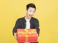 Happy young man holding gift box Royalty Free Stock Photo