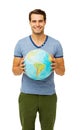 Happy Young Man Holding Globe Royalty Free Stock Photo