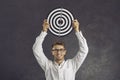 Happy young man holding shooting target to show concept of setting business goals Royalty Free Stock Photo