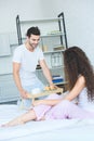 happy young man holding tray with breakfast and looking at girlfriend Royalty Free Stock Photo