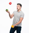 Happy young man juggling pepper