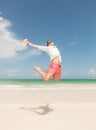 Happy young man jumping on the beach Royalty Free Stock Photo