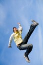 Happy young man - jumping end flies in blue sky. Royalty Free Stock Photo