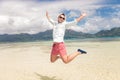 Happy young man jumping of joy on the beach Royalty Free Stock Photo