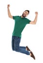 Happy young man jumping on white background