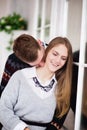 Happy young man kissing his girlfriend in the neck Royalty Free Stock Photo