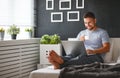 Happy young man with laptop and cup of coffee in bed Royalty Free Stock Photo