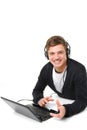 Happy young man with laptop and headphones