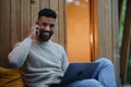 Happy young man with laptop and smartphone resting outdoors in a tree house, weekend away and remote office concept Royalty Free Stock Photo