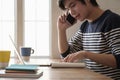 Happy young man learn language listen lecture watch webinar write notes look at laptop sit in home, distant education