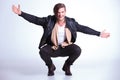Happy young man in leather jacket jumps welcomes you Royalty Free Stock Photo