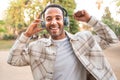 Happy young man listening music and dancing with headphones on the street. Space for text Royalty Free Stock Photo