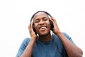 Happy young man listening to music on headphones Royalty Free Stock Photo